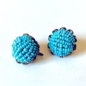 Vintage clip on earrings. 1 inch. Blue glass seed bead design.